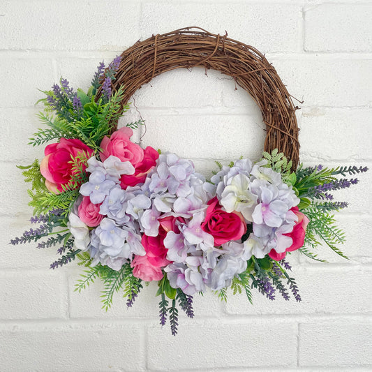 Flower wreath with purple hydrangeas and pink roses