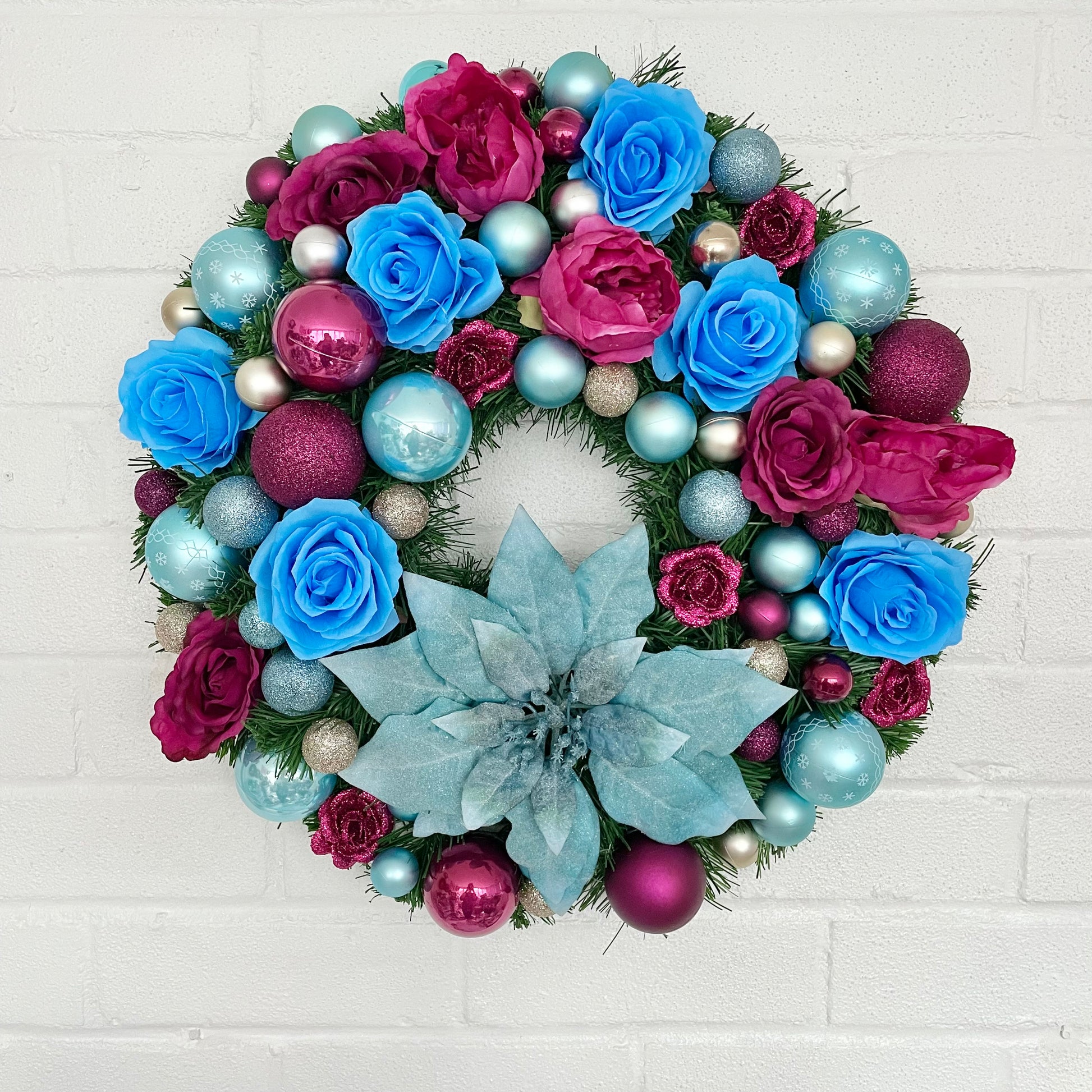 Big Christmas door wreath. Pink and blue baubles and flowers 