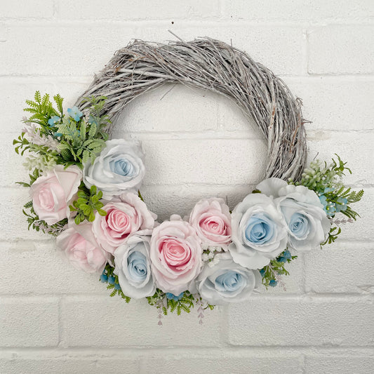 Flower door wreath with a grey twig base and baby blue and pink roses